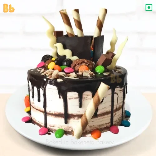 Black Treasure Cake, a cake loaded with chocolates and gems, cake available for online ordering and free home delivery in Noida and Ghazibad.