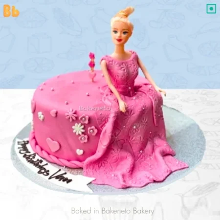 Are you looking for Fondant Doll cake designs? Then you can Order this Pink Fondant Doll Cake online by bakeneto.com and get free home delivery in just 5 hours on the same-day in Indirapuram, Vaishali, Vasundhara, Kaushambi, Gaur City, Noida Extension and Noida.