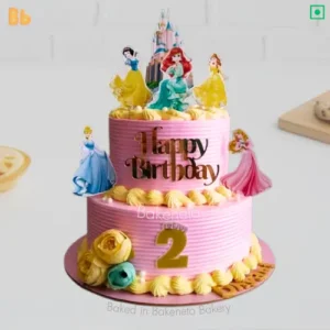 Princess Desire Cake is the pink color cake with 2d edible print of many princess on it, cake looks amazing in green, yellow flowers. Best cake design for daughter birthday. Order princess cake online and get cake delivery in NCR (Noida, Ghaziabad, Delhi, Greater Noida Extension by bakeneto.com), call: 7071634634 for instant booking for birthday cakes.